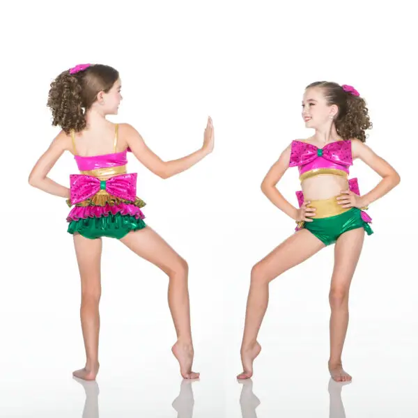 Young dancer modeling vibrant pink, green, and gold costume