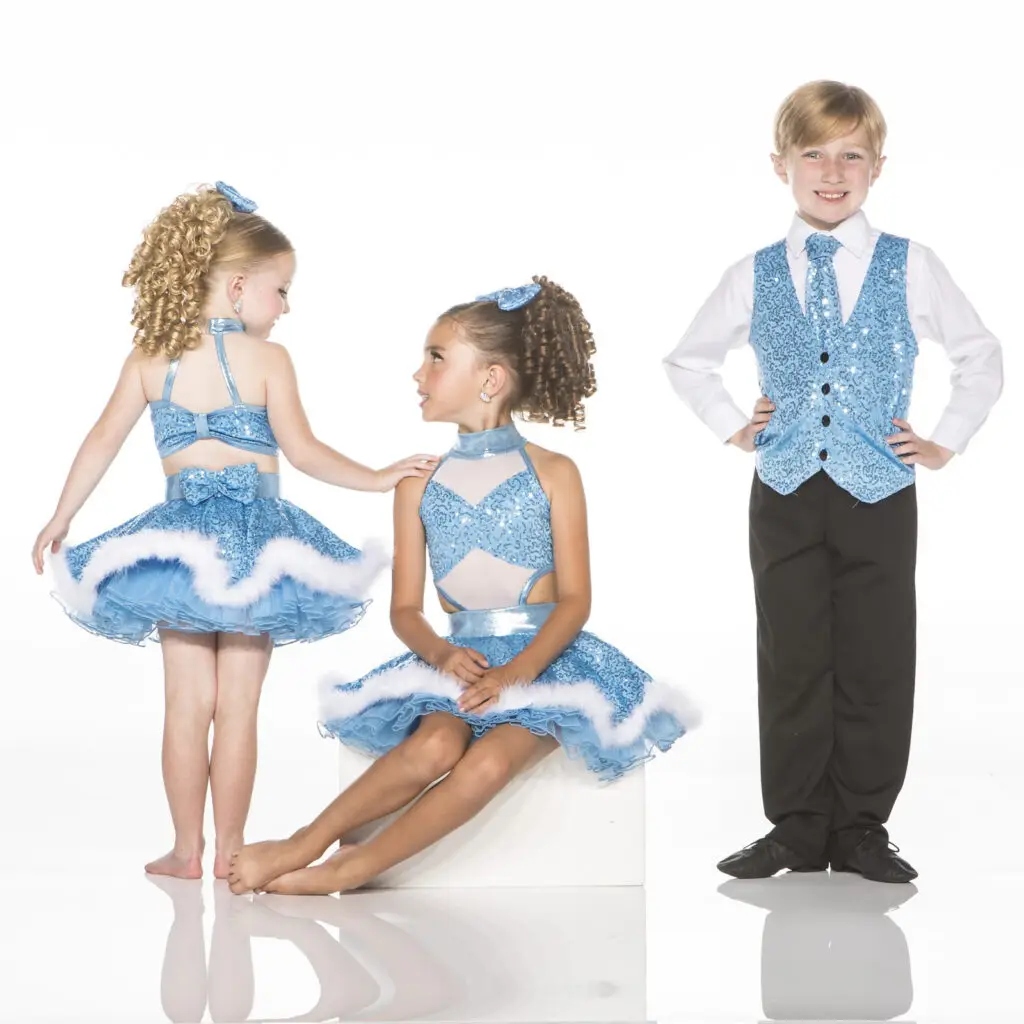 Three children wearing blue sequined dance costumes