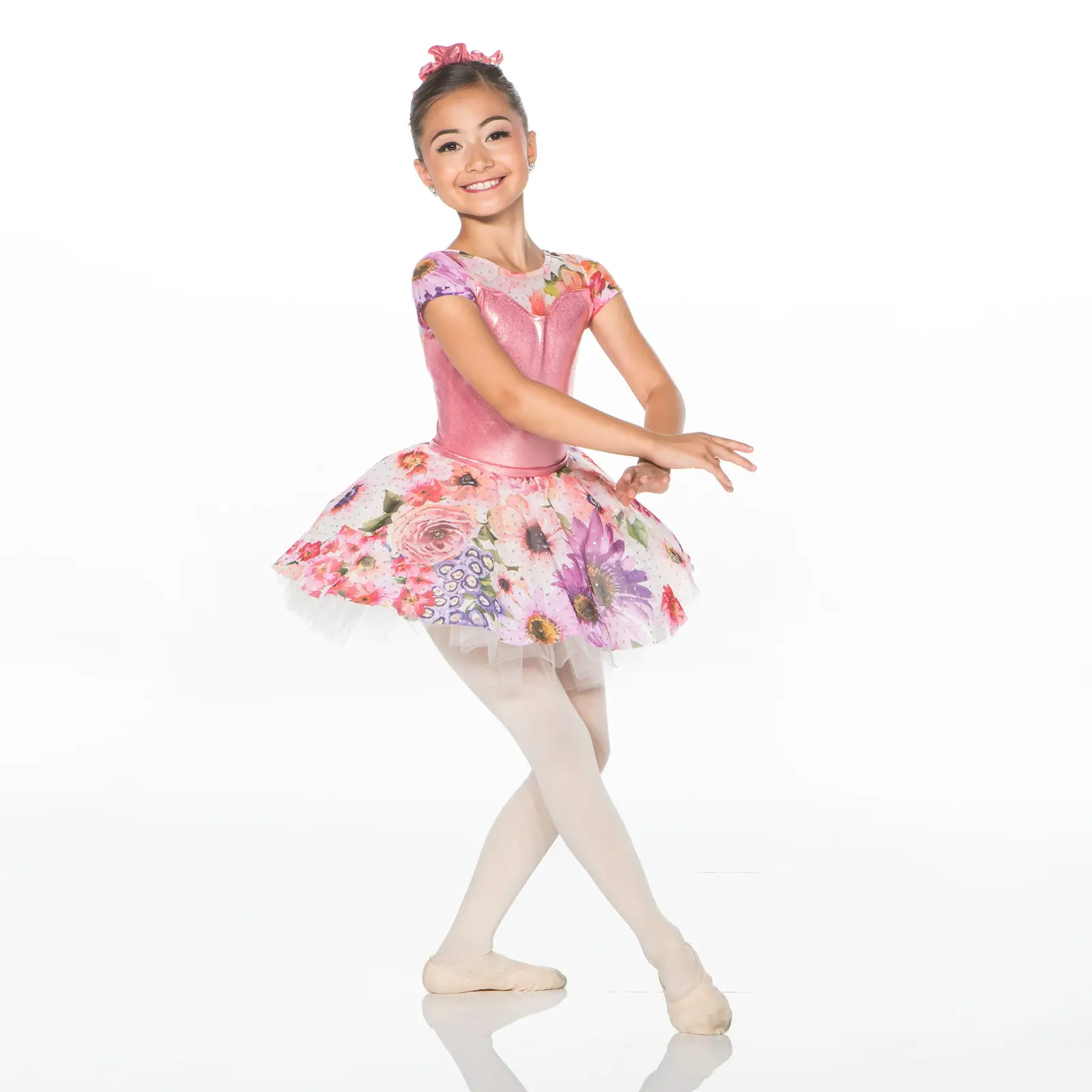 Young ballerina posing in pink floral tutu
