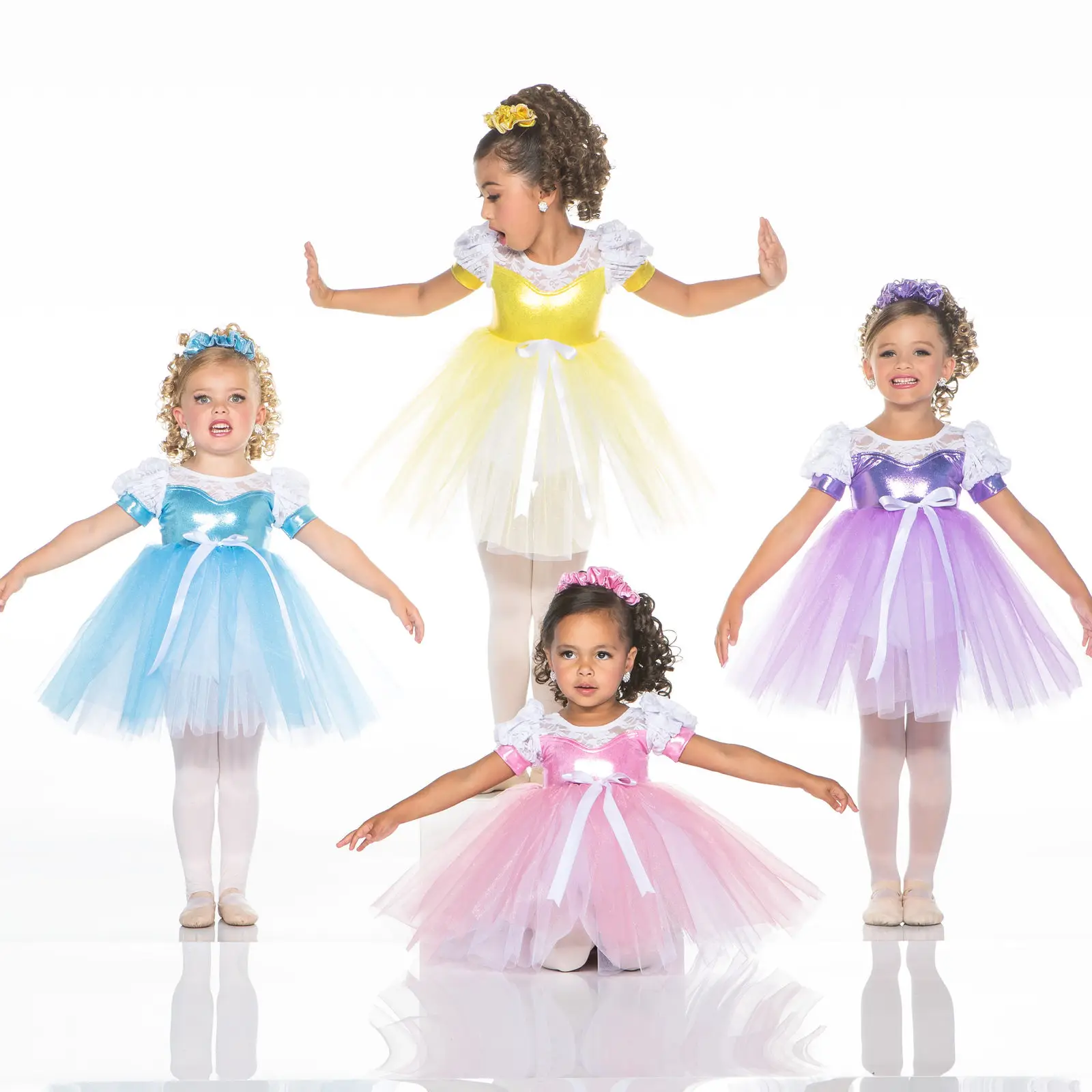 Four young girls wearing colorful princess ballet dresses