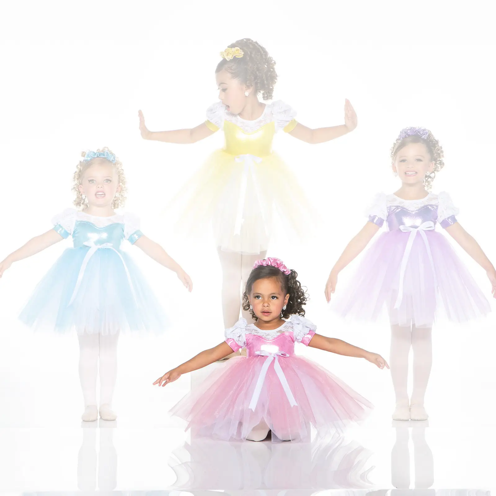 Four young girls wearing colorful princess-style ballet dresses