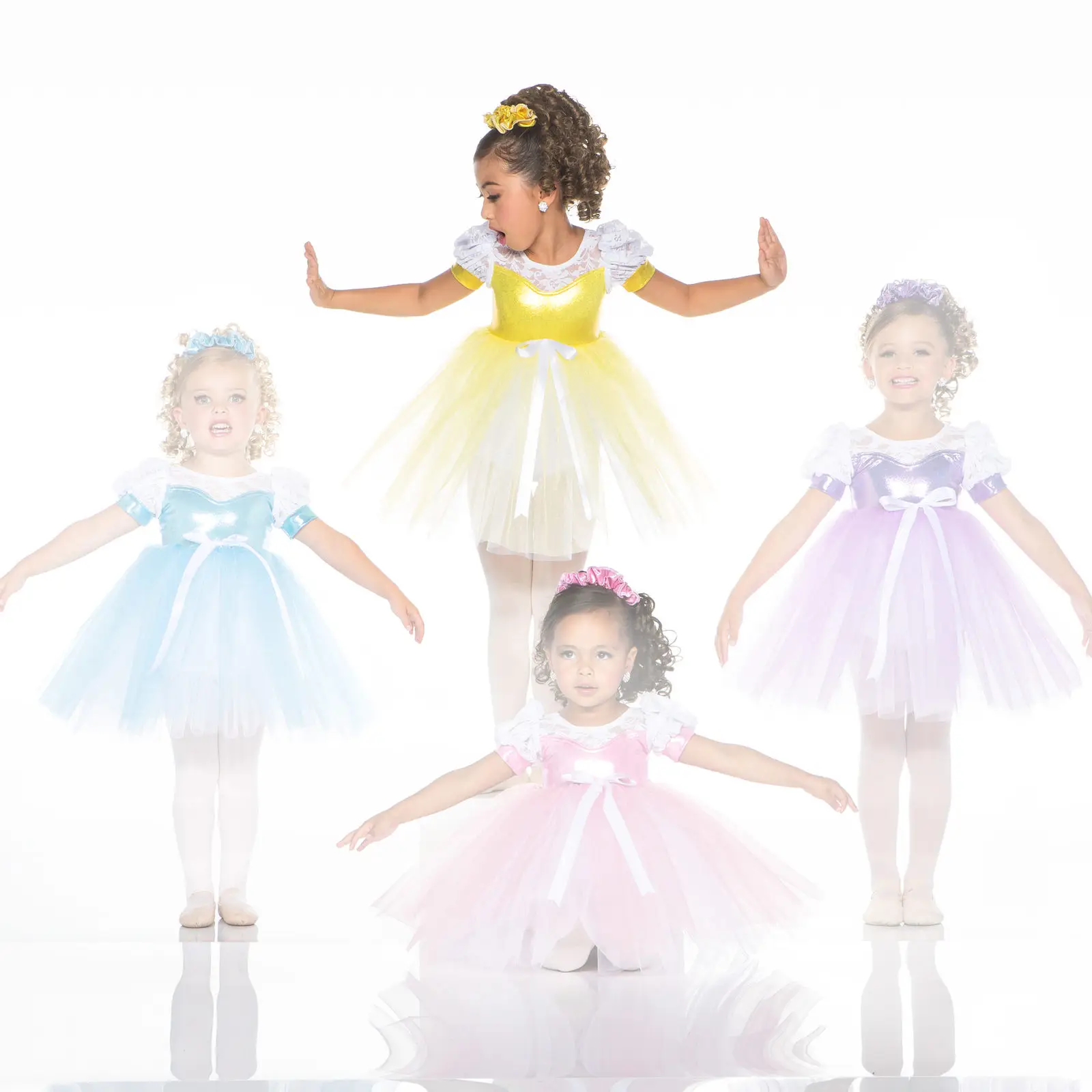 Four young girls wearing colorful princess-style ballet dresses