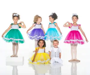 Children modeling colorful dance costumes against a white studio background