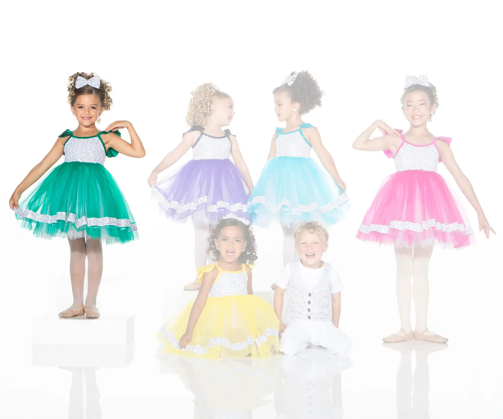 Children modeling colorful formal dresses and a white vest