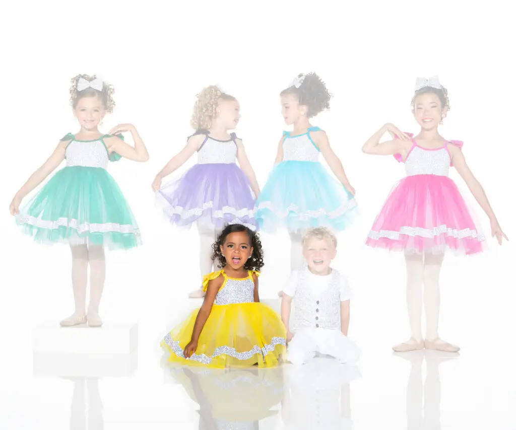 Children modeling colorful tutu dresses and a white vest