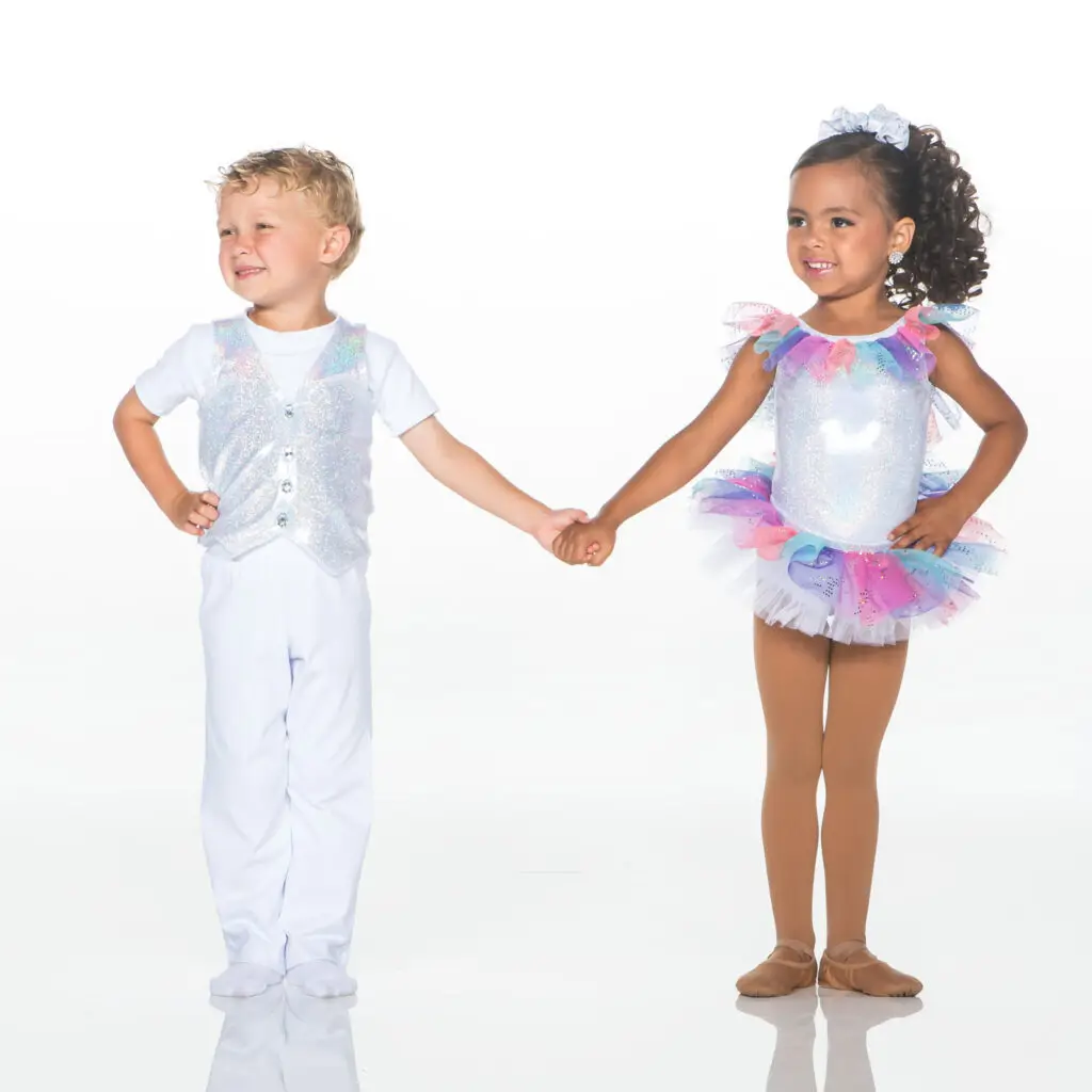 Two children holding hands in colorful dance costumes