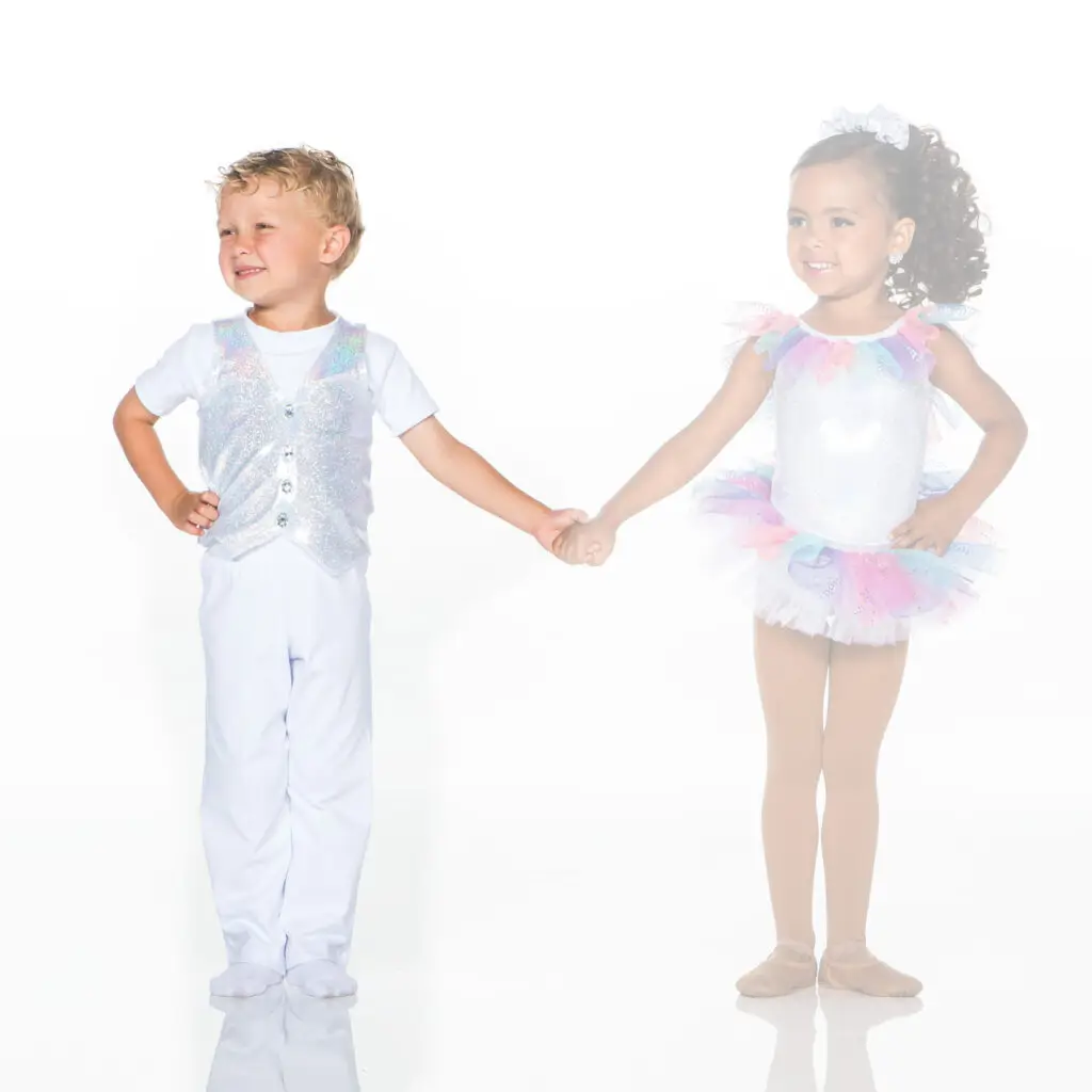 Young boy and girl holding hands in glitter costumes