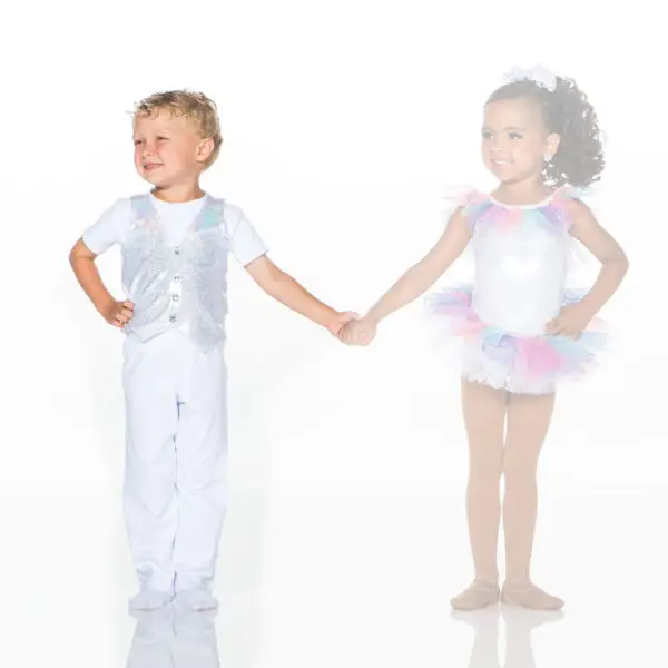 Young boy and girl holding hands in glitter costumes