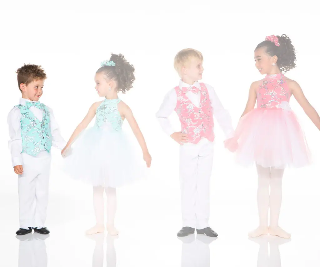Four children wearing colorful formal dance costumes
