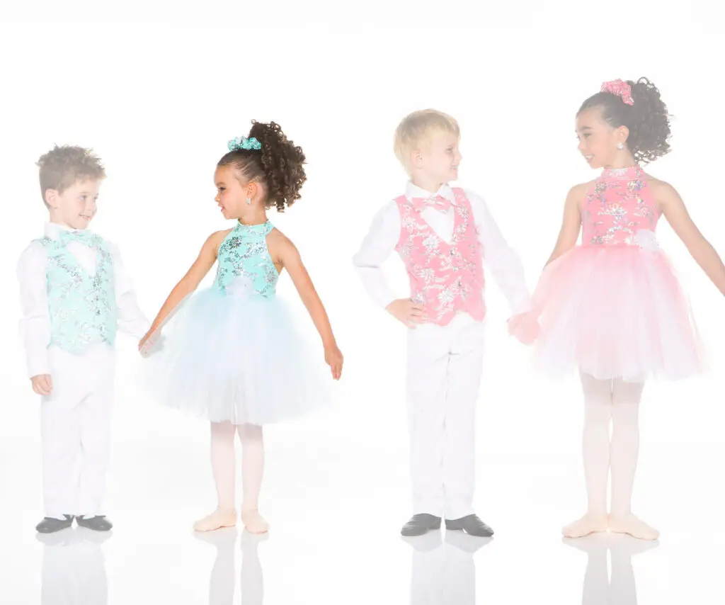 Four children wearing colorful formal dance costumes