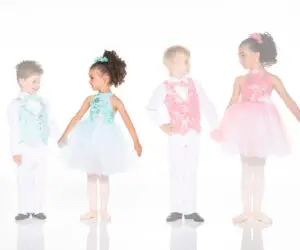Four children wearing colorful formal dance costumes