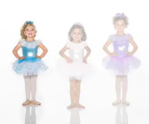 Three young girls wearing colorful ballet tutu costumes