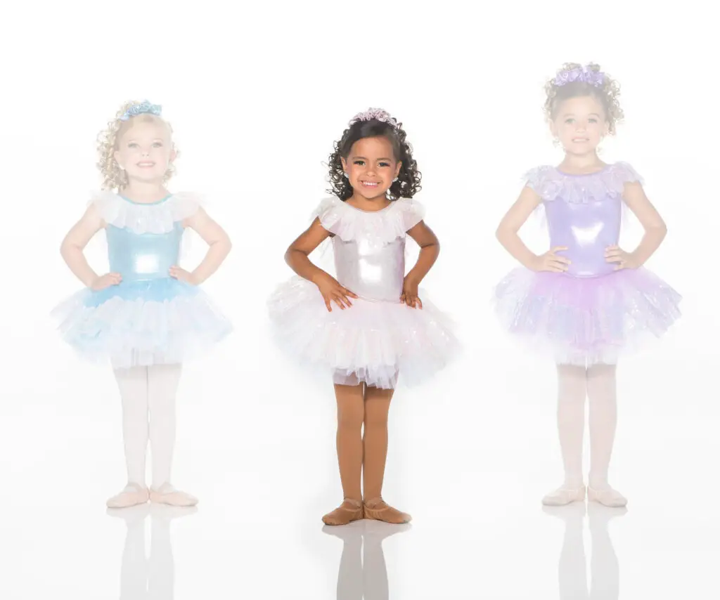 Three young ballerinas wearing pastel sparkly tutus