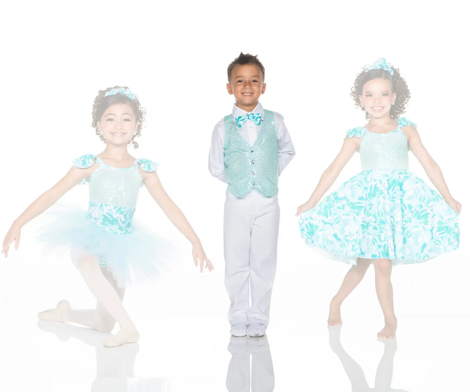 Three children in turquoise formal dance outfits posing
