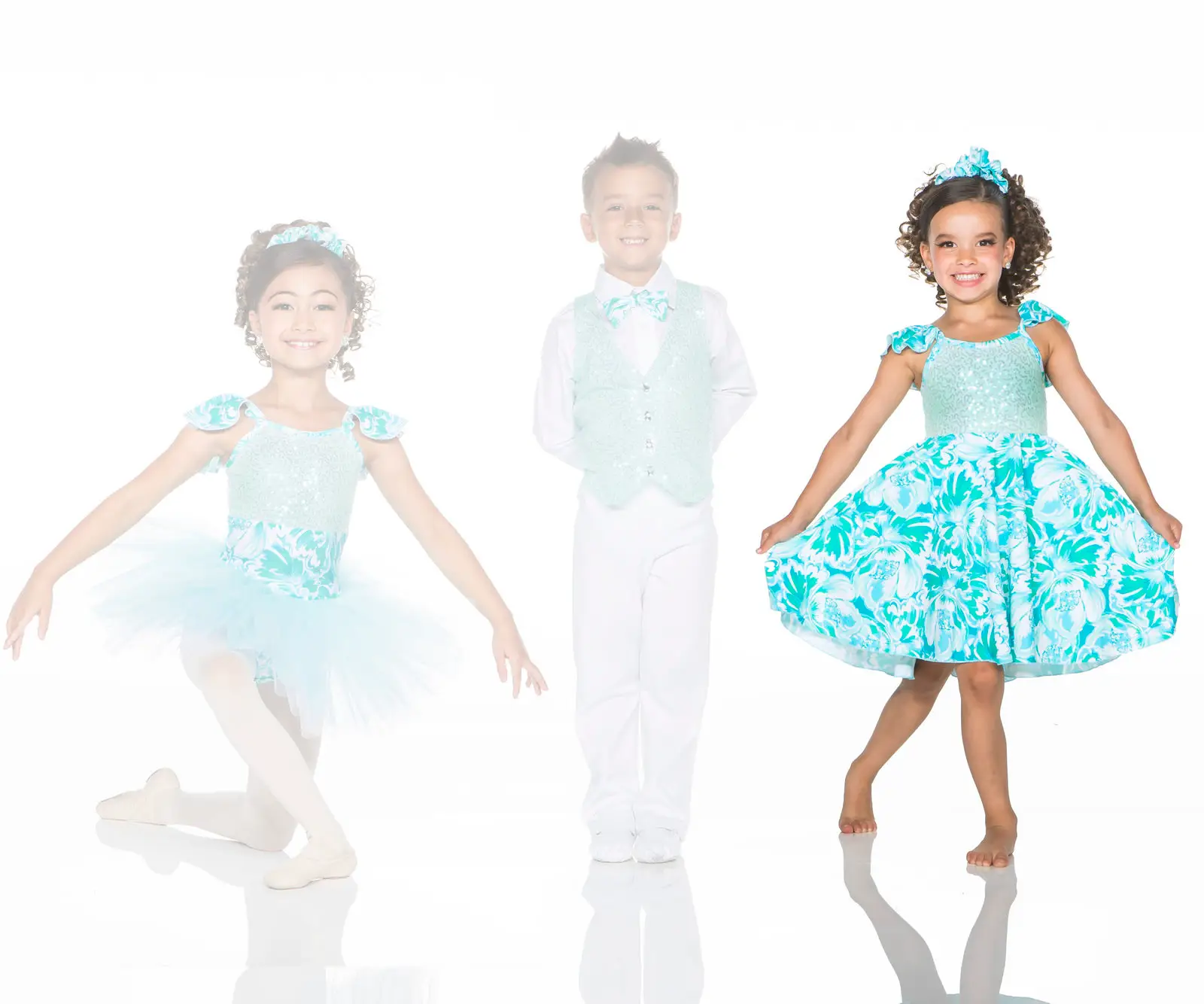 Three children modeling turquoise floral dance costumes