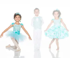Three children wearing turquoise dance costumes against white background