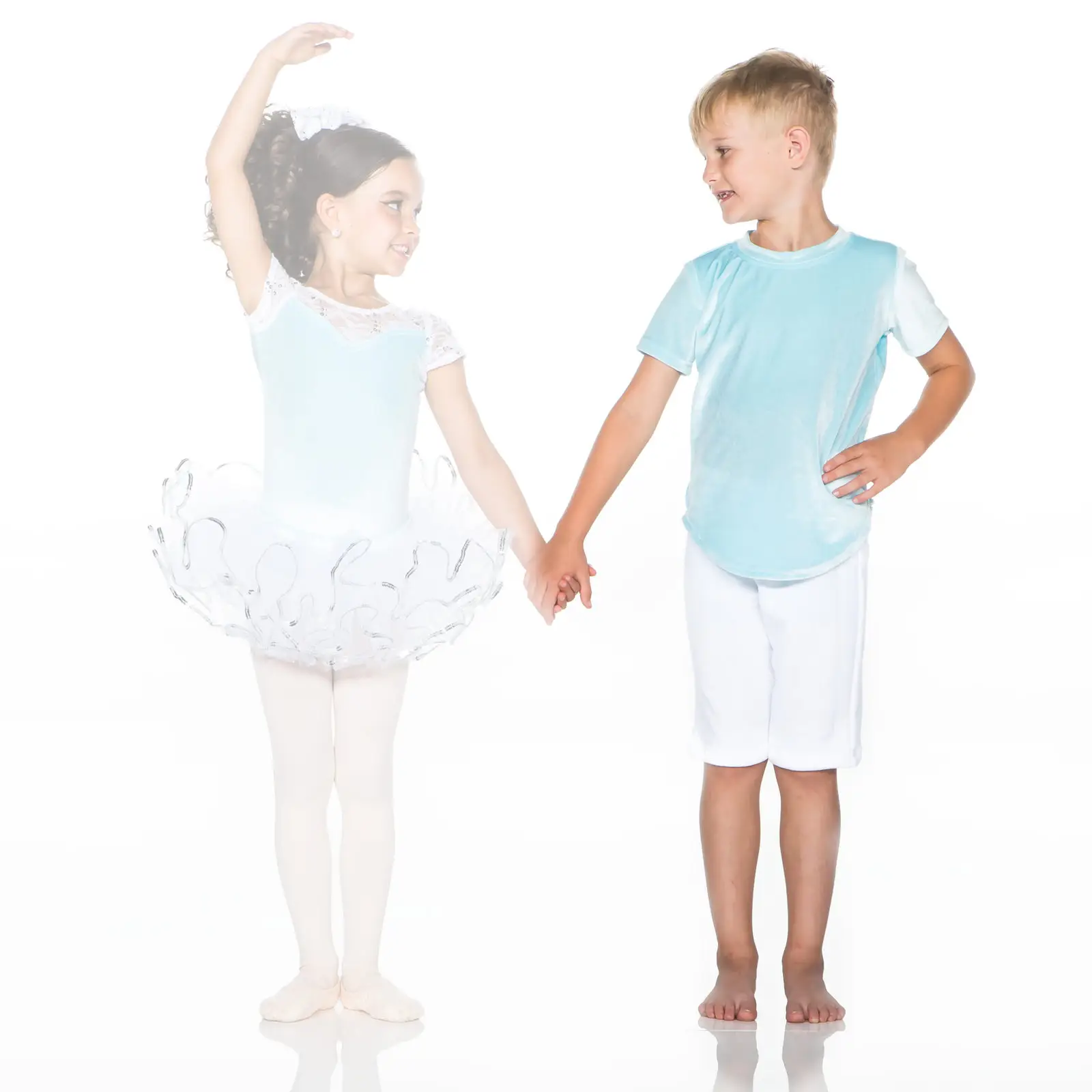 Young ballet dancer holding hands with barefoot boy