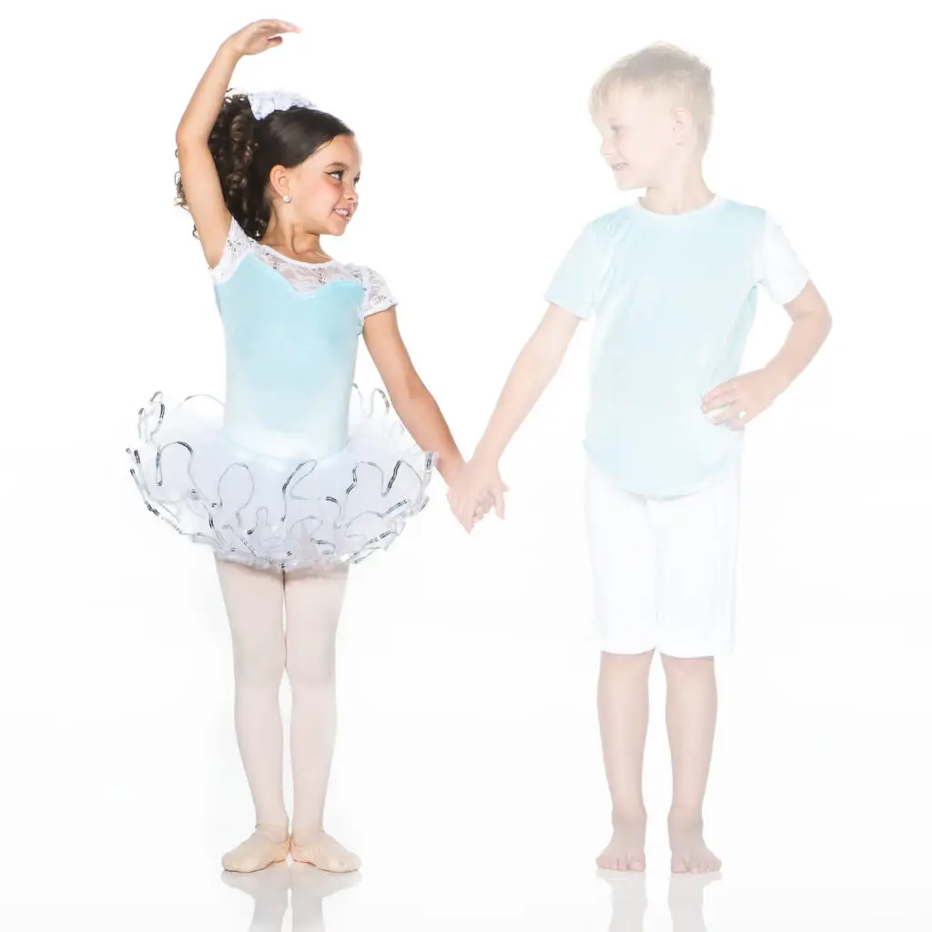 Young ballerina and boy holding hands on white background
