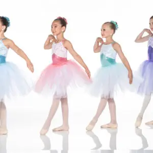 Four young ballerinas in colorful tutus posing against white background.