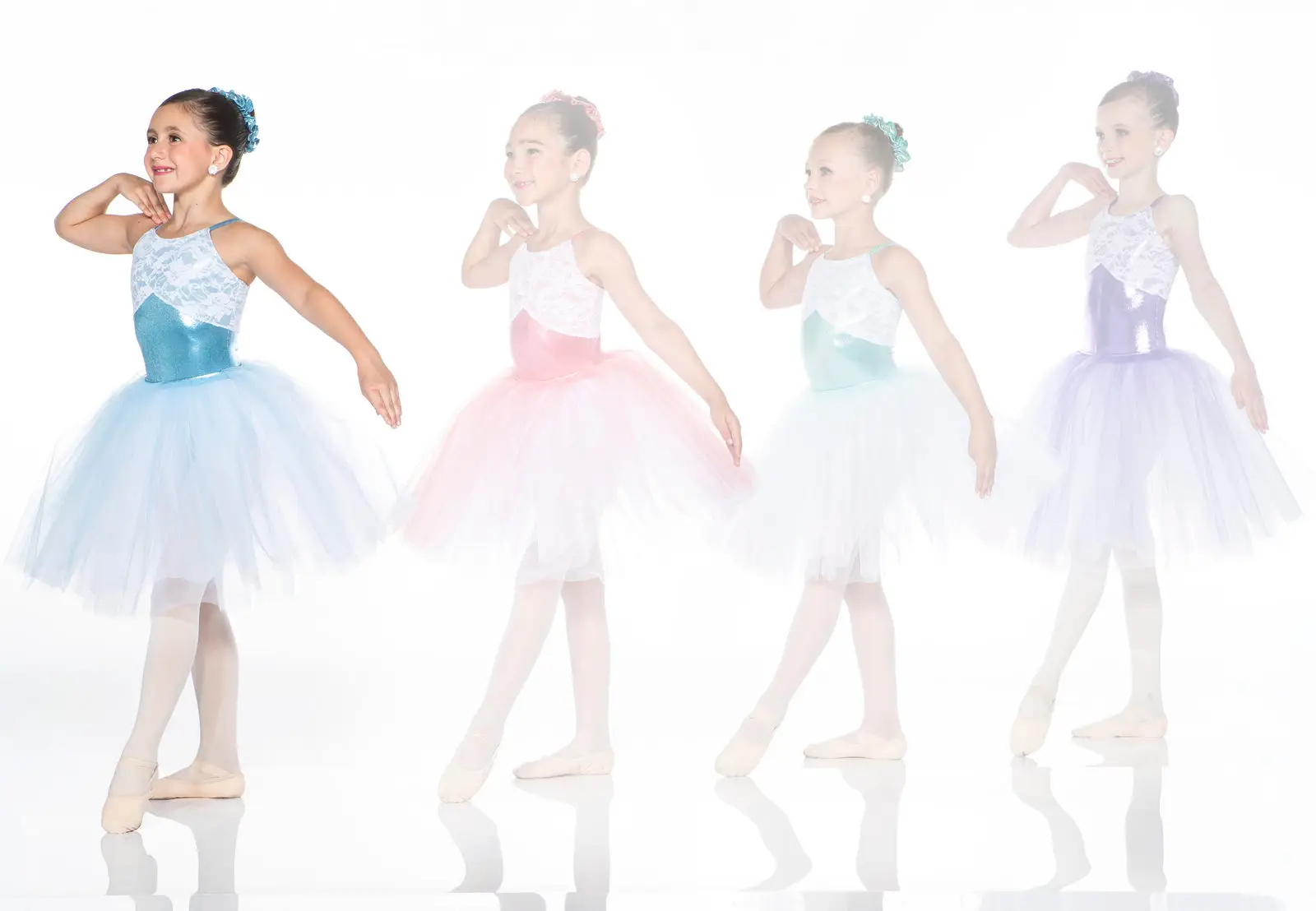 Four young ballerinas modeling pastel tutu dresses