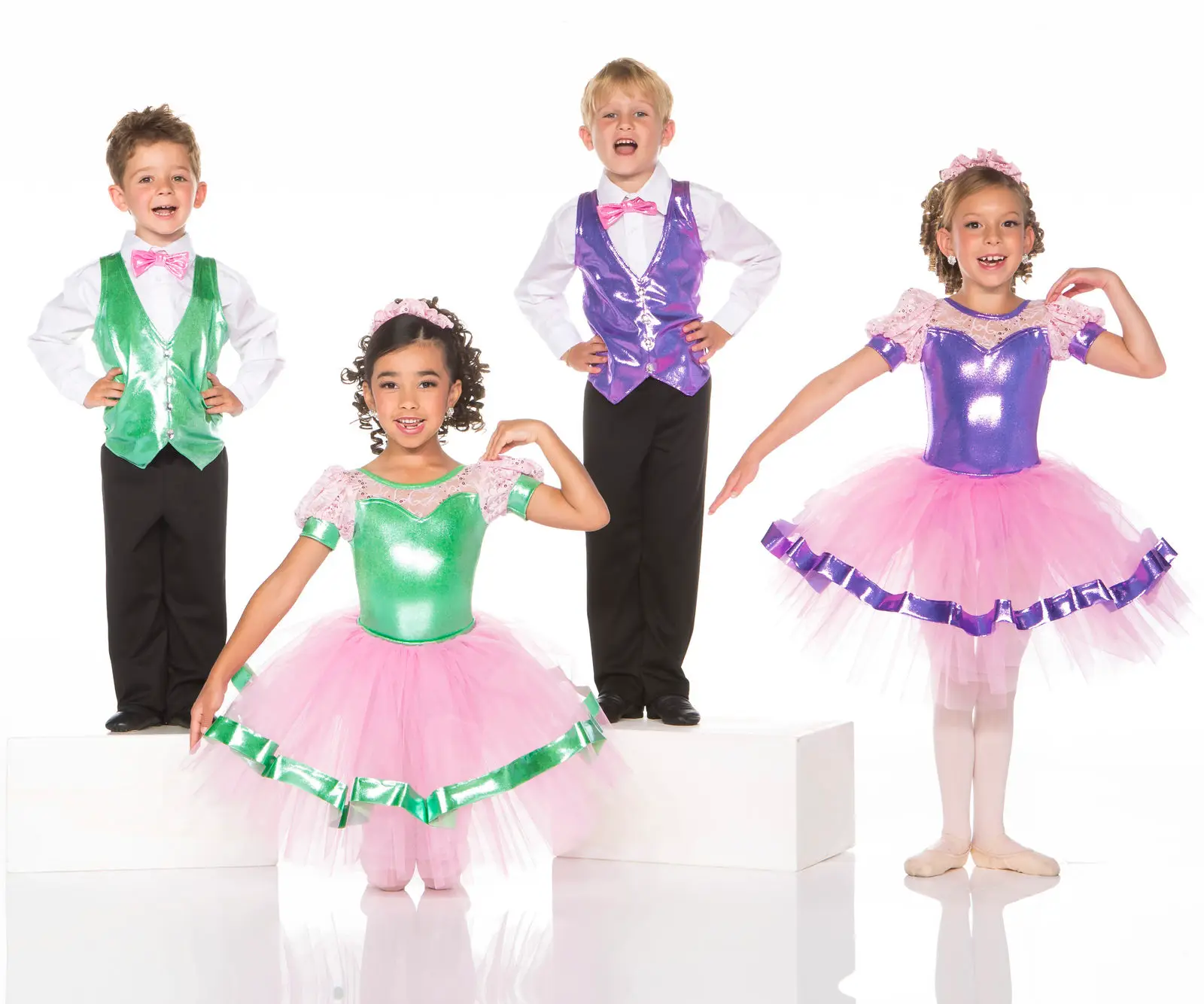 Four children wearing colorful ballet and dance costumes