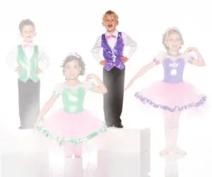 Children wearing colorful dance costumes pose in a studio