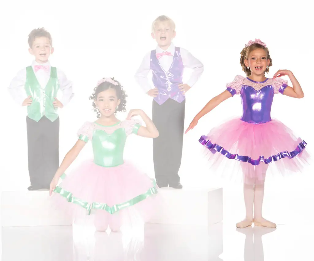Four children wearing colorful dance costumes and ballet tutus