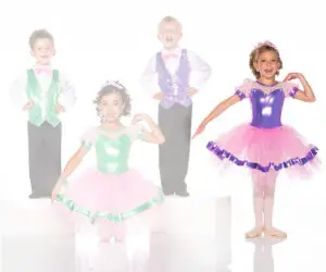 Four children wearing colorful dance costumes and ballet tutus