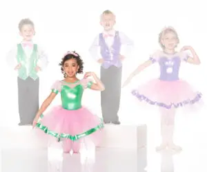 Four children posing in colorful dance costumes