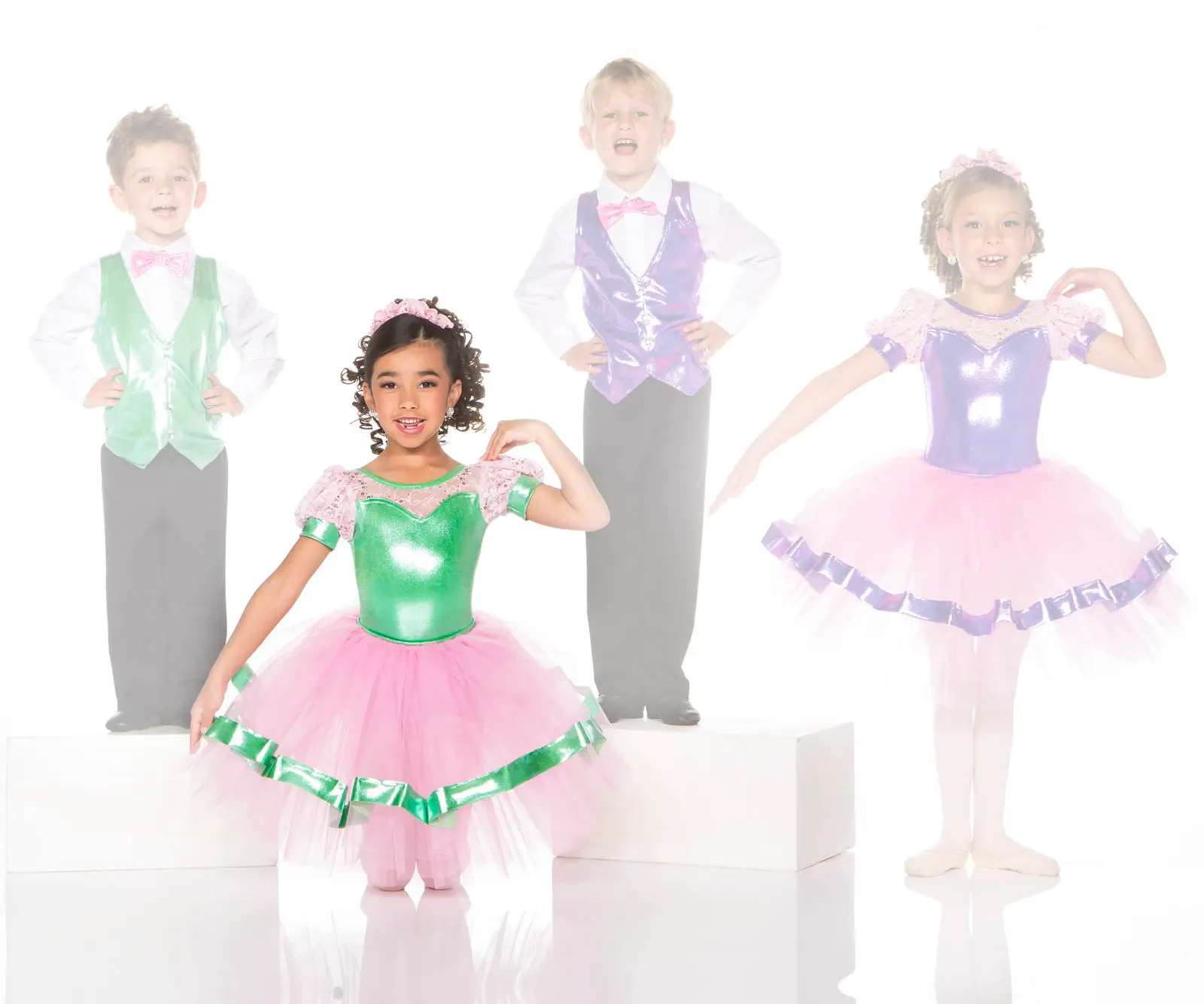 Four children posing in colorful dance costumes
