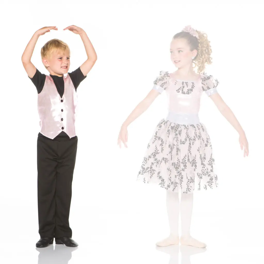 Young boy and girl in dance costumes posing together
