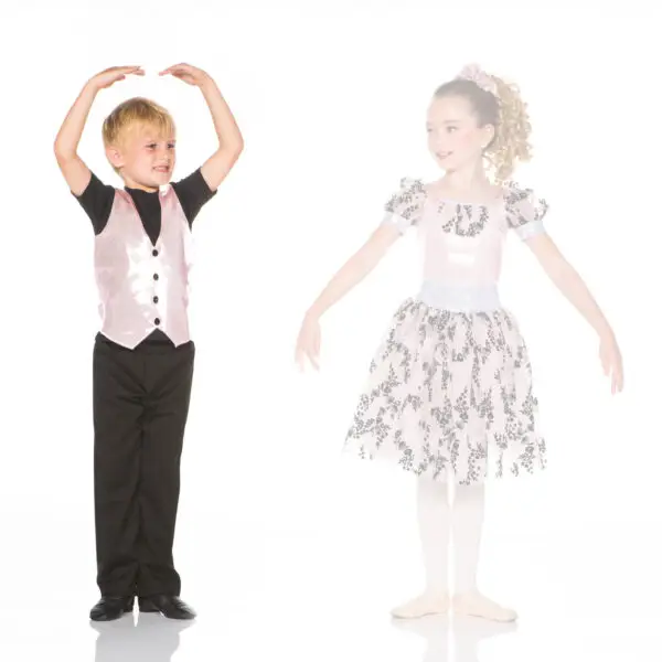 Young boy and girl in dance costumes posing together
