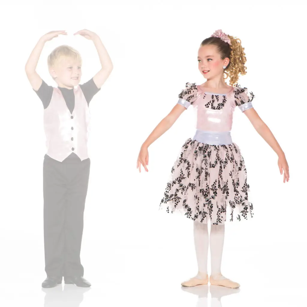 Young ballet dancers in costumes posing against white background