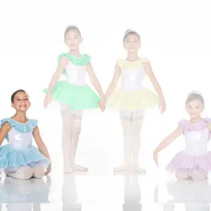 Four young ballet dancers wearing colorful tutus