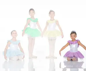Four young dancers wearing colorful pastel ballet costumes