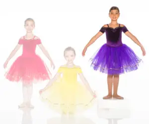 Three girls wearing colorful ballet dresses on a white background
