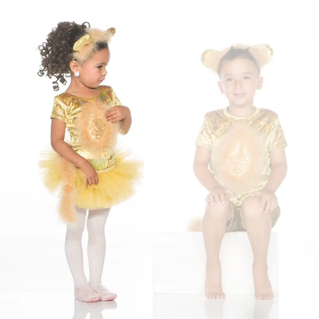 Two children wearing golden lion costumes against a white background.