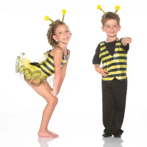 Two children wearing bee costumes against a white background.
