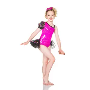 Young dancer in a pink sequined costume posing