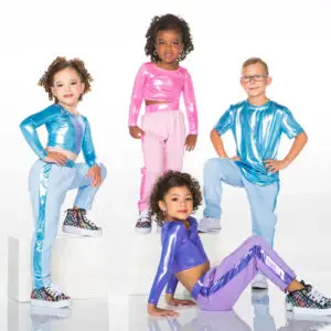 Four children wearing colorful metallic dance outfits pose together.