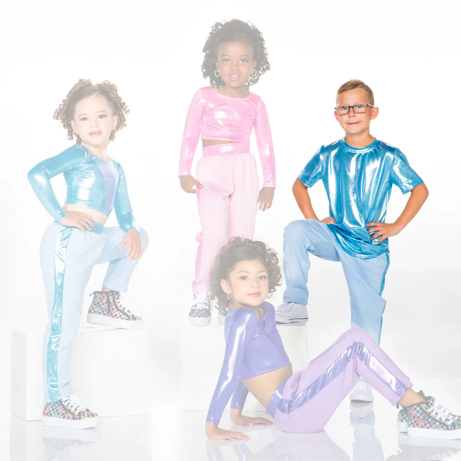 Four children pose in colorful metallic dance outfits.