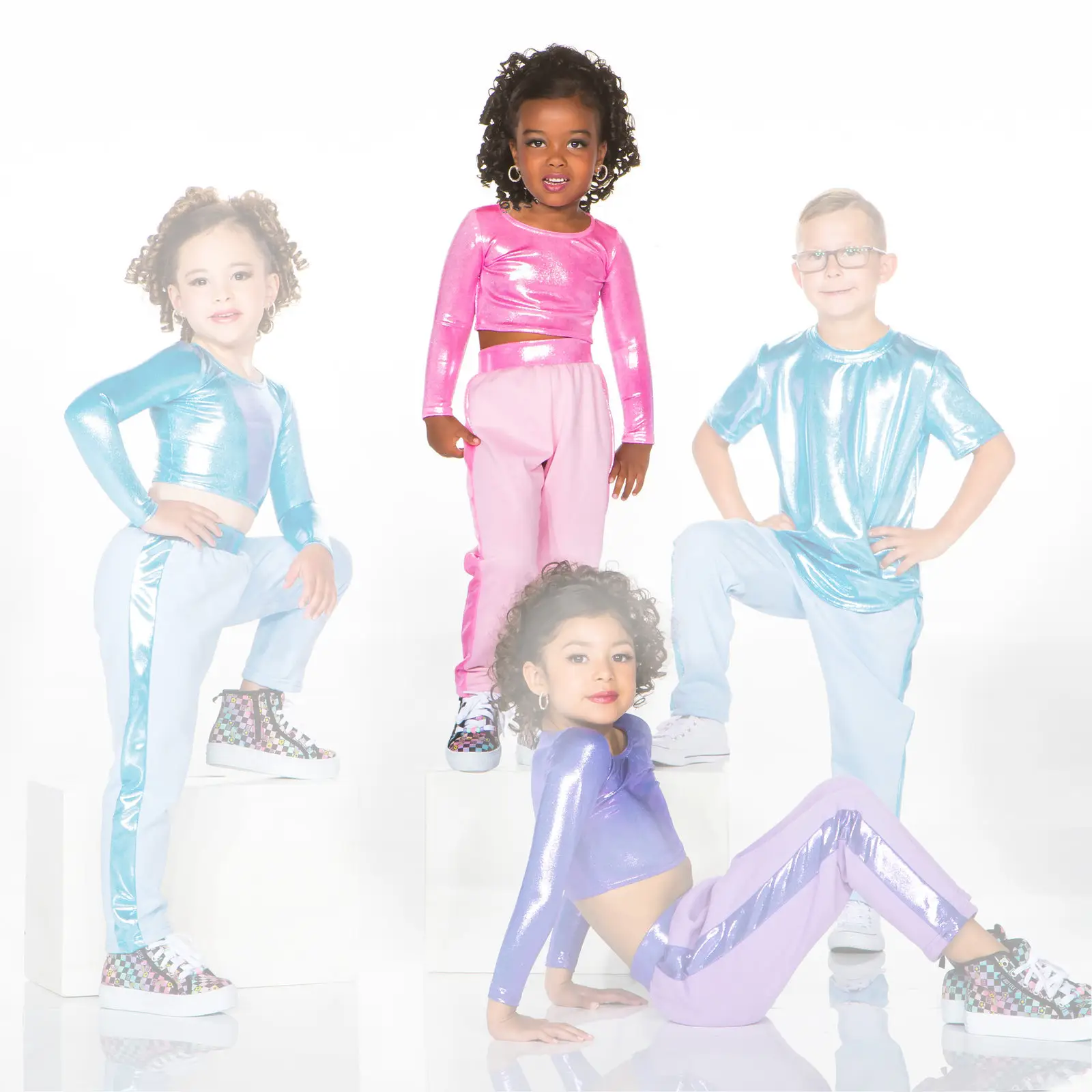 Four children pose in colorful metallic dance outfits.