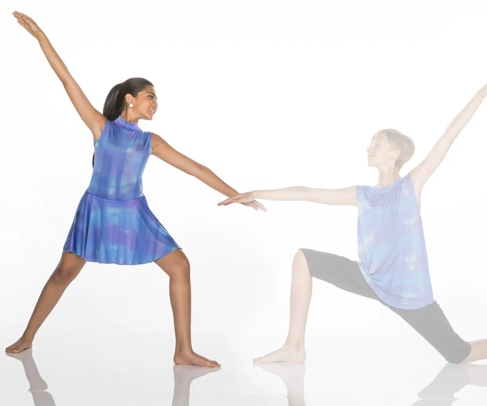 Two dancers in blue costumes pose against white background.