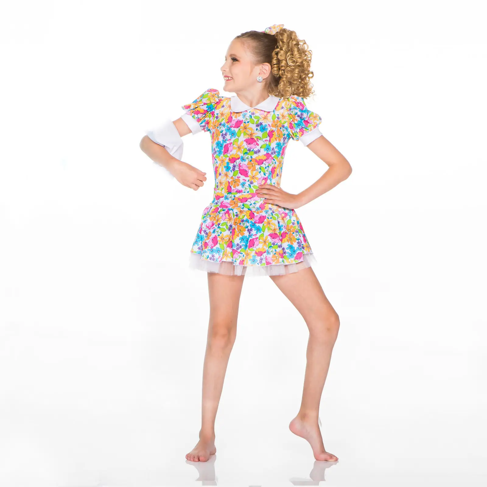 Young girl posing in a colorful floral dress
