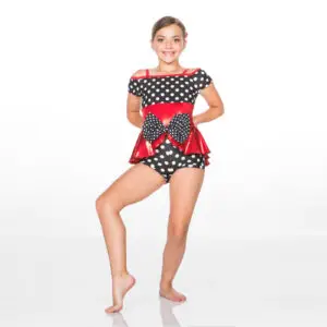Young dancer wearing polka-dot costume with red bow