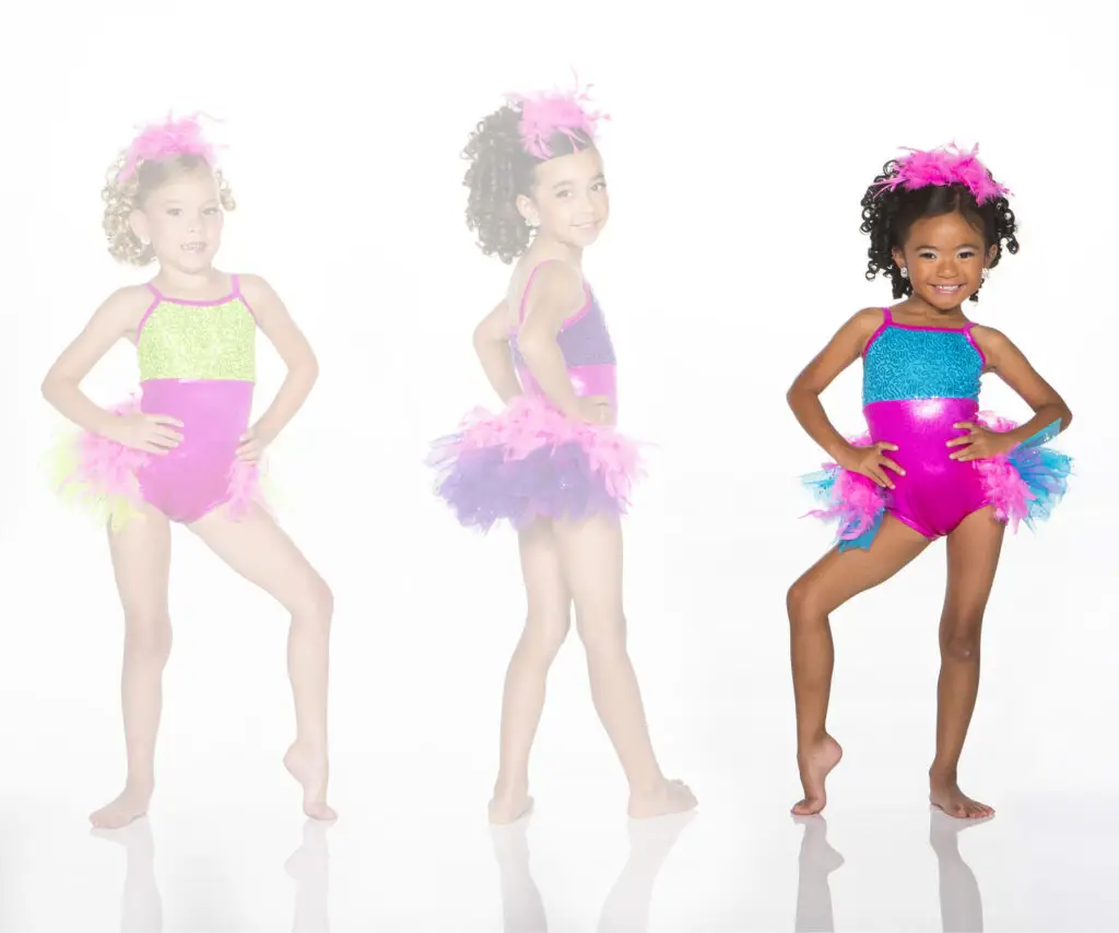 Three young girls modeling colorful feathered dance costumes