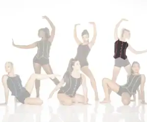 Five dancers posing in black leotards with colorful trim
