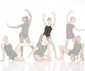 Six dancers pose in black leotards with colorful trim.