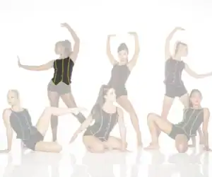 Six dancers pose in black costumes with colorful trim.