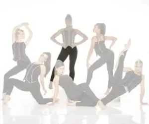 Six women pose in black outfits with colorful piping.